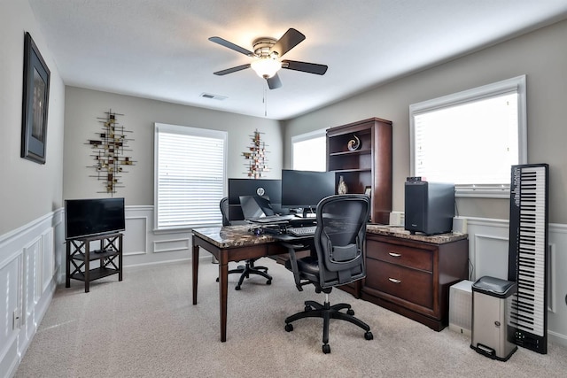 carpeted office space featuring a wealth of natural light and ceiling fan