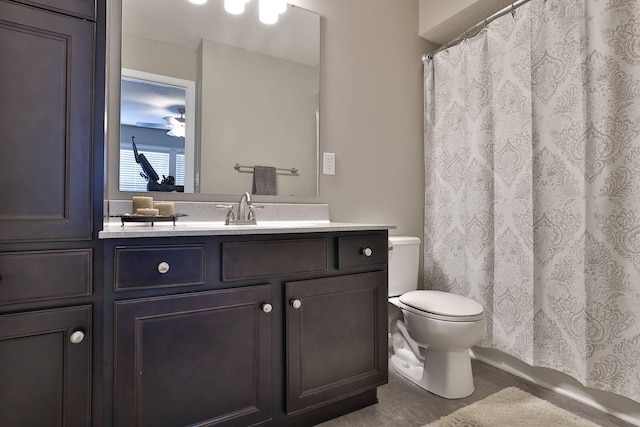 bathroom with vanity, ceiling fan, toilet, and a shower with shower curtain