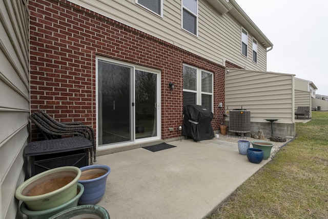 view of patio / terrace with central AC and a grill