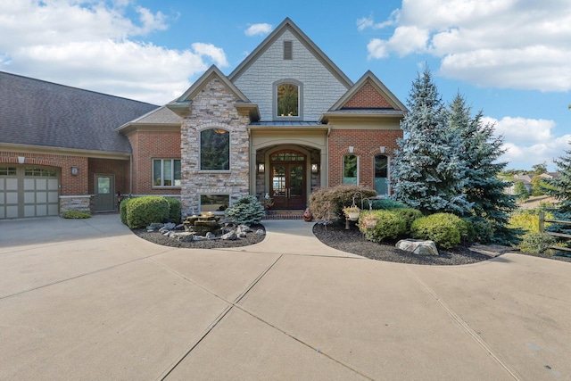 view of front of house with a garage and french doors