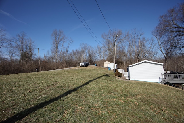 view of yard with an outbuilding and a wooden deck