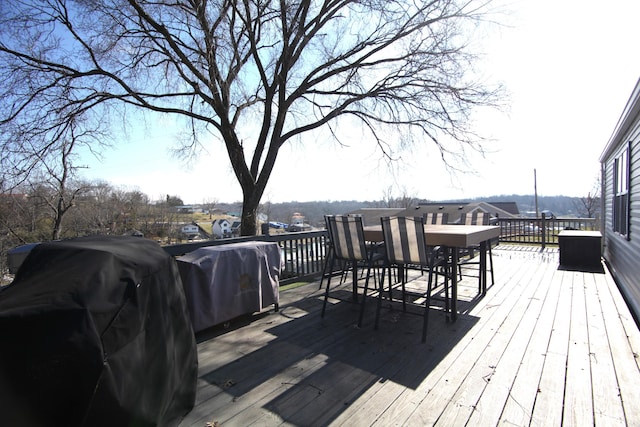 wooden deck with a grill