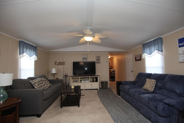 living area featuring lofted ceiling with beams, ceiling fan, ornamental molding, and light colored carpet