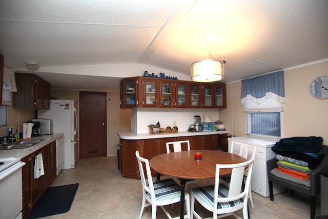 kitchen with electric range oven, lofted ceiling, glass insert cabinets, light countertops, and a sink