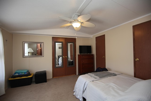 carpeted bedroom featuring ceiling fan, vaulted ceiling, and french doors