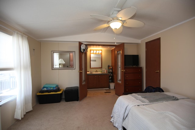 bedroom with light carpet, vaulted ceiling, a ceiling fan, and ensuite bathroom