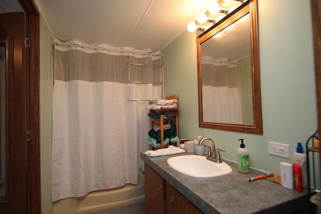 full bath with a textured ceiling, shower / bath combination with curtain, and vanity