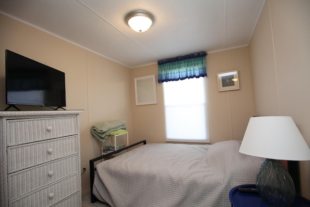 bedroom with a decorative wall and crown molding