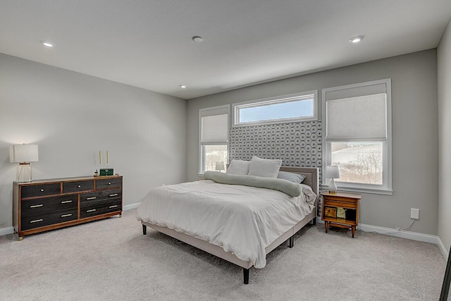 bedroom featuring recessed lighting, light carpet, and baseboards