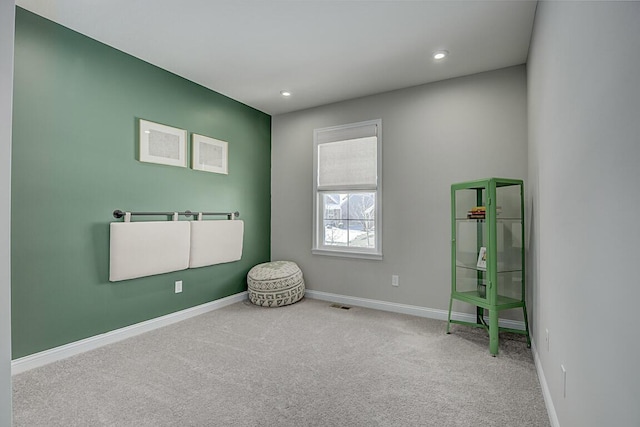 empty room featuring recessed lighting, carpet flooring, visible vents, and baseboards