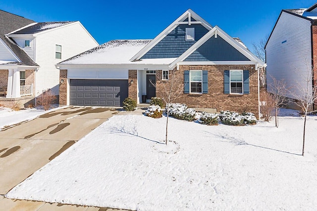 view of front of house with driveway, an attached garage, and brick siding