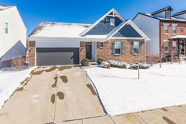 view of front of house with a garage, brick siding, and driveway