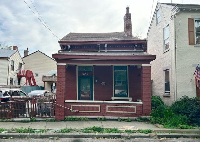 508 Craig St, Covington, KY 41011 - view of front of property featuring covered porch, brick siding, fence, and a chimney