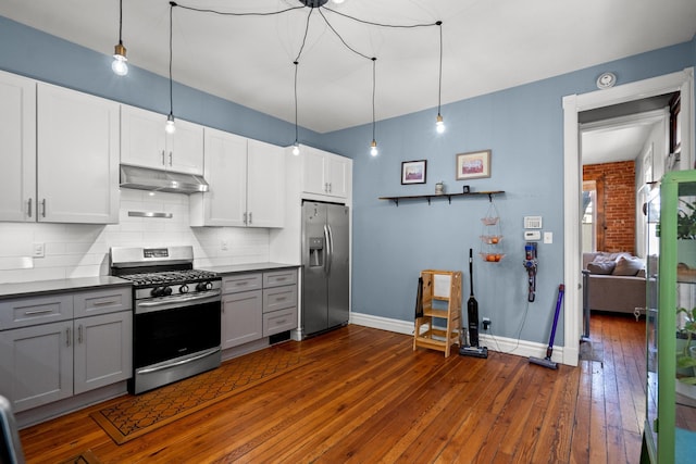 kitchen with appliances with stainless steel finishes, pendant lighting, gray cabinetry, white cabinets, and decorative backsplash