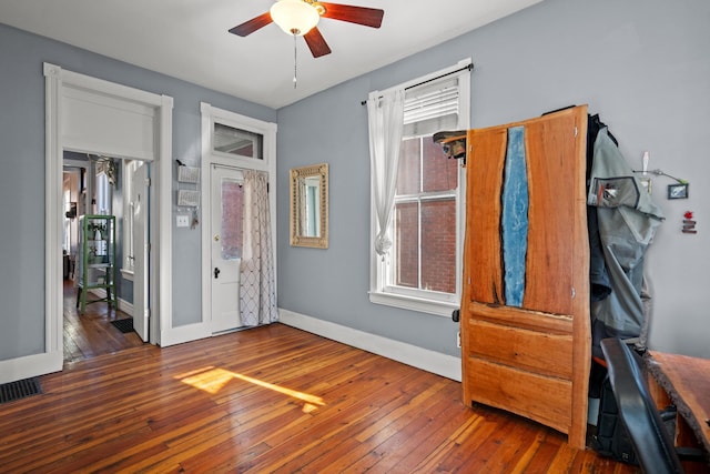 bedroom with ceiling fan and dark hardwood / wood-style flooring