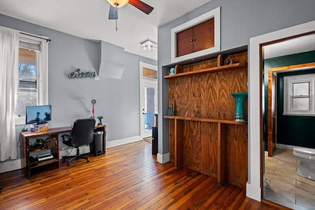 home office featuring dark wood-type flooring and ceiling fan