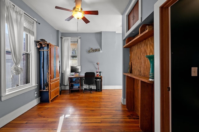 office space with dark hardwood / wood-style floors and ceiling fan