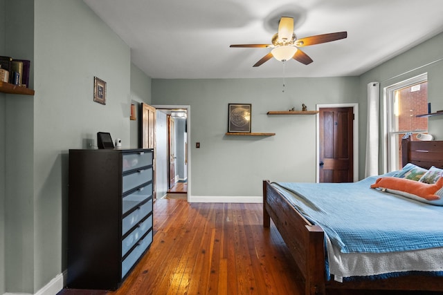 bedroom with ceiling fan and dark hardwood / wood-style flooring