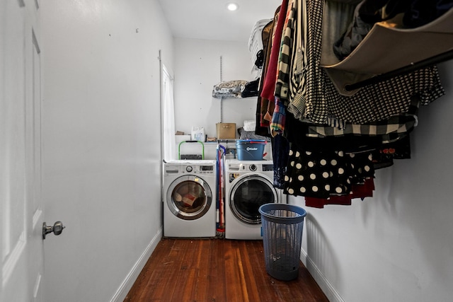 laundry area with dark hardwood / wood-style floors and washing machine and dryer