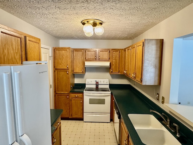 kitchen featuring sink, a textured ceiling, and white appliances