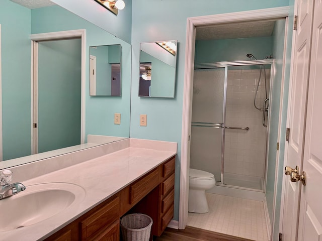 bathroom featuring walk in shower, tile patterned floors, toilet, a textured ceiling, and vanity