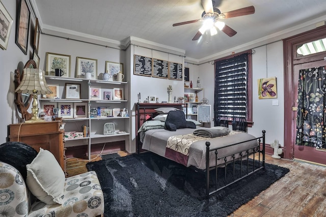 bedroom with crown molding, ceiling fan, and hardwood / wood-style flooring