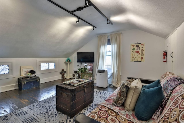 living room featuring vaulted ceiling, dark wood-type flooring, and a textured ceiling