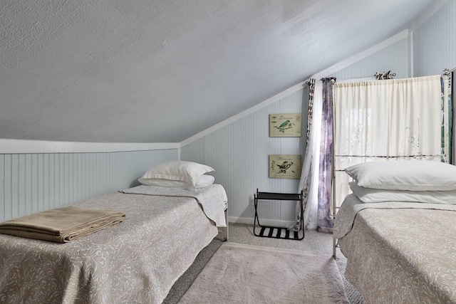 carpeted bedroom with lofted ceiling and a textured ceiling