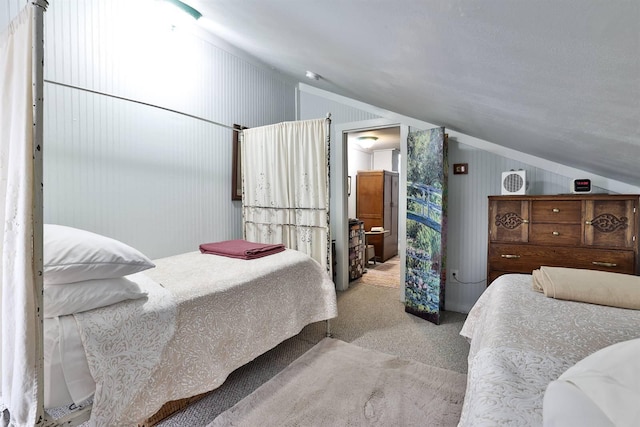 bedroom with lofted ceiling and light carpet