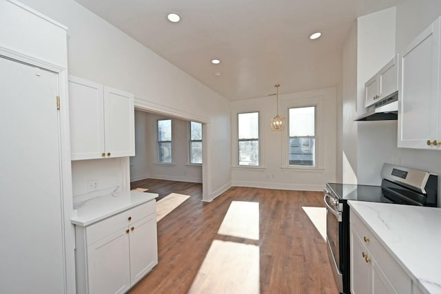 kitchen featuring pendant lighting, stainless steel electric range, white cabinetry, light stone counters, and vaulted ceiling