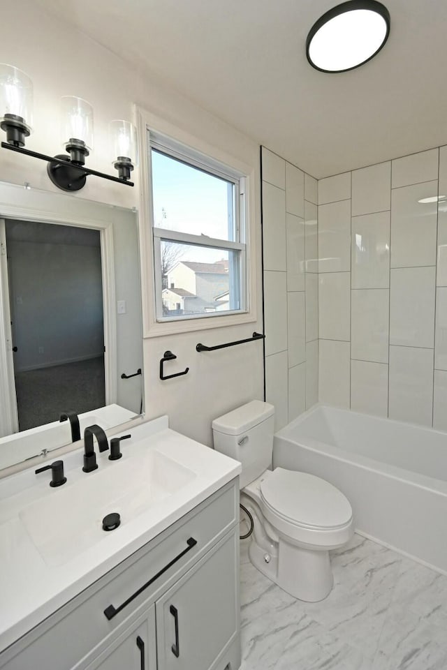 full bathroom with vanity, tiled shower / bath combo, and toilet