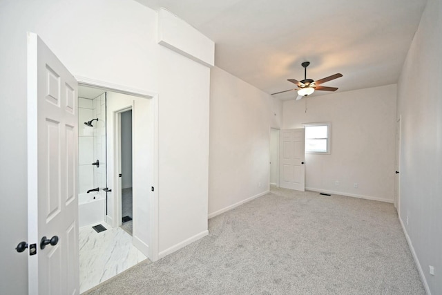 empty room featuring ceiling fan and light colored carpet