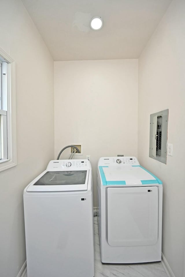 clothes washing area with electric panel and washing machine and clothes dryer