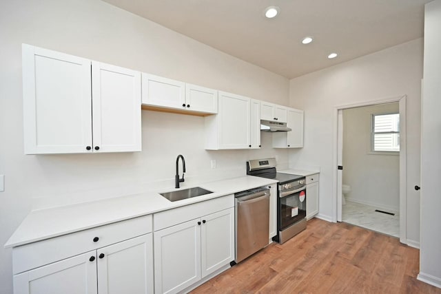 kitchen with white cabinetry, sink, and appliances with stainless steel finishes