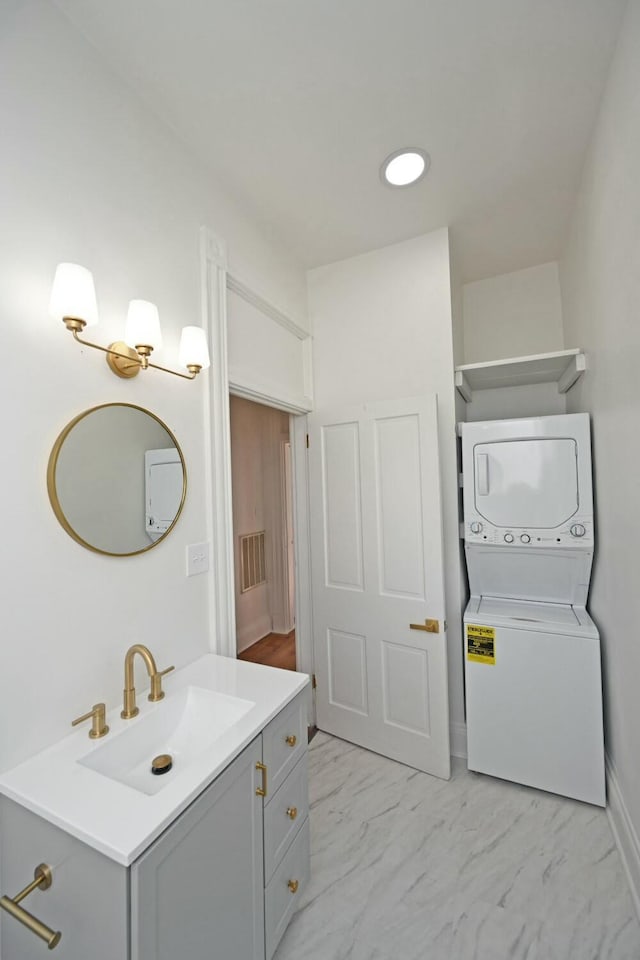 bathroom featuring vanity and stacked washer / drying machine