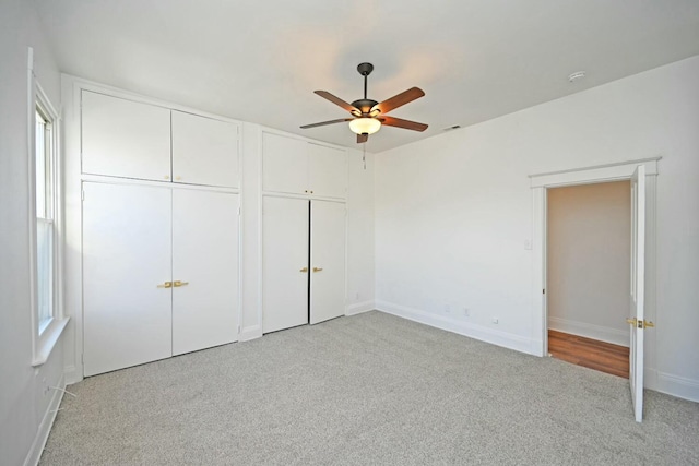 unfurnished bedroom with light carpet and ceiling fan