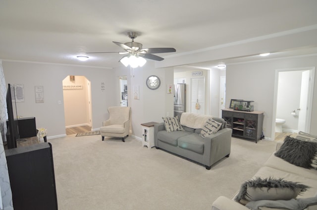 living room featuring crown molding, light colored carpet, and ceiling fan