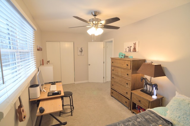 carpeted bedroom featuring ceiling fan and a closet