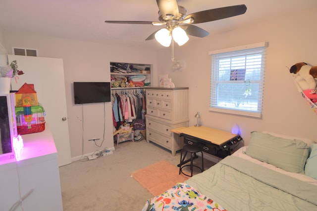 bedroom featuring ceiling fan, light colored carpet, and a closet