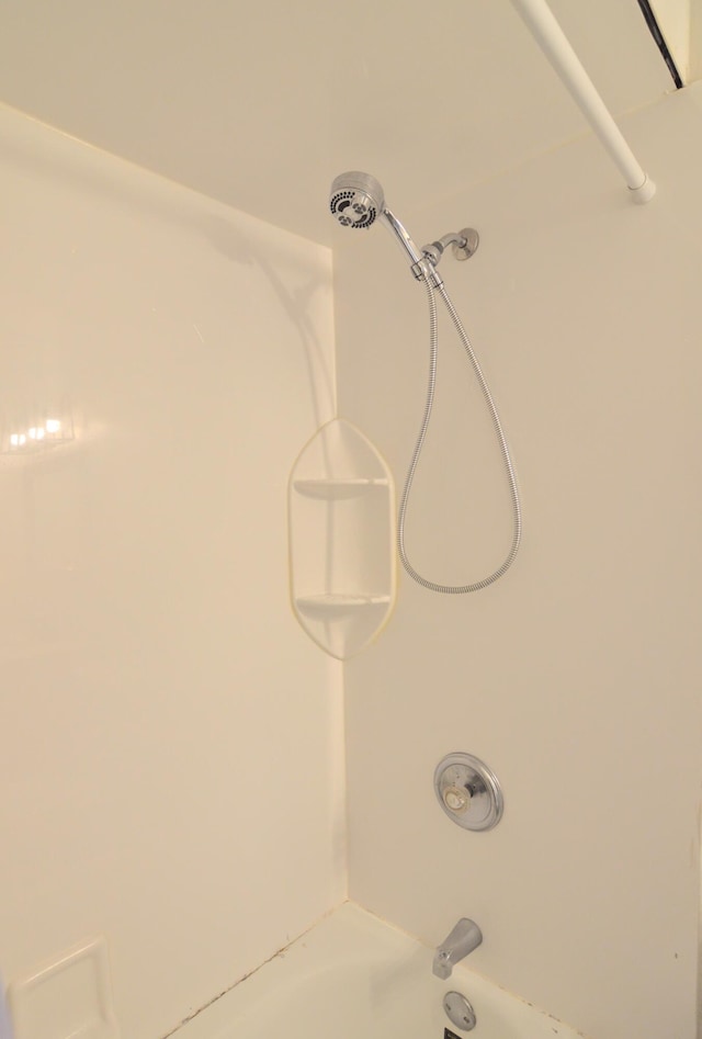 interior details with shower / washtub combination