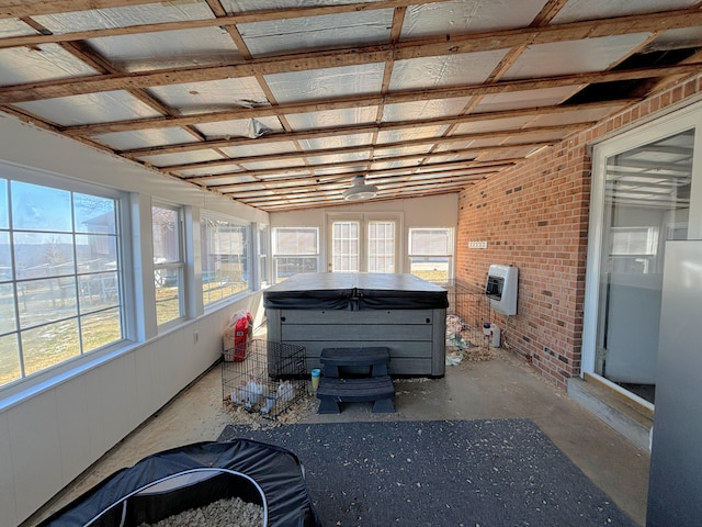 unfurnished sunroom featuring heating unit