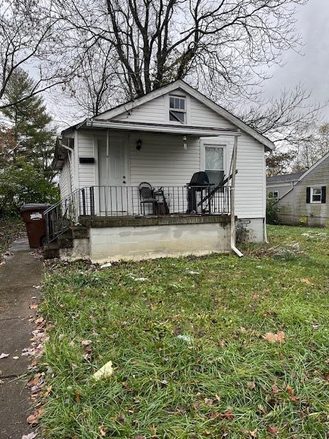 bungalow-style home with a front yard