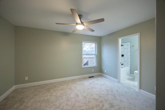 unfurnished bedroom with light carpet, ensuite bath, and ceiling fan