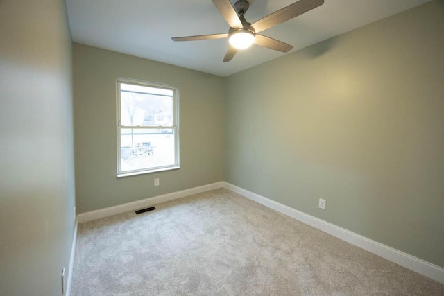 carpeted spare room featuring ceiling fan