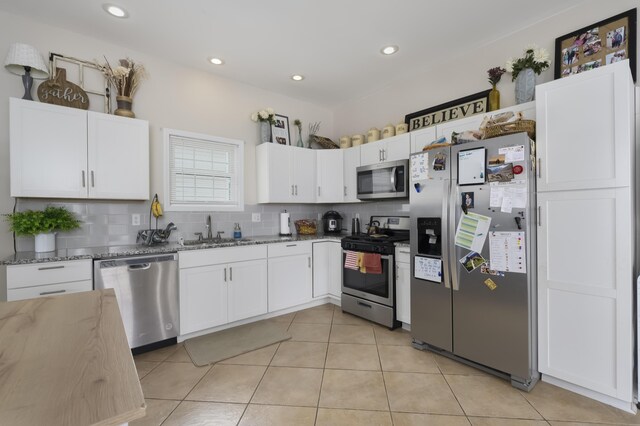 3408 Cowie Ave, Erlanger, KY 41018 - kitchen with sink, appliances with stainless steel finishes, light stone counters, white cabinets, and decorative backsplash