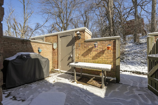 snow covered patio featuring grilling area