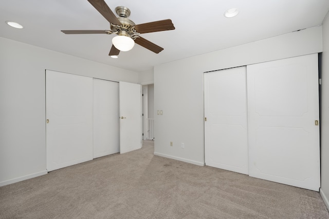 unfurnished bedroom with ceiling fan and light carpet