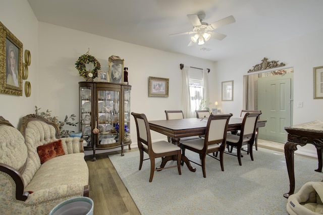 dining area featuring hardwood / wood-style floors and ceiling fan