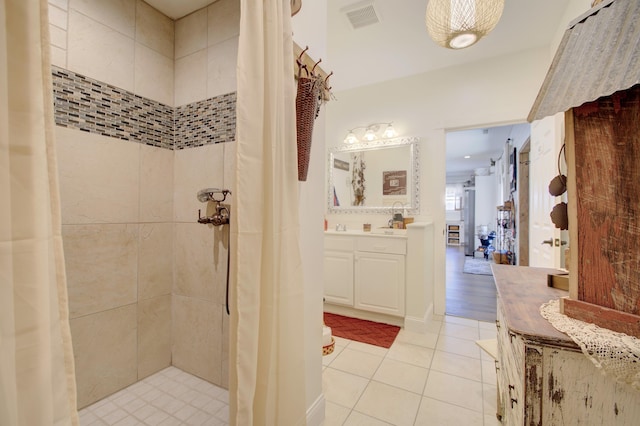 bathroom with a shower with curtain, vanity, and tile patterned flooring