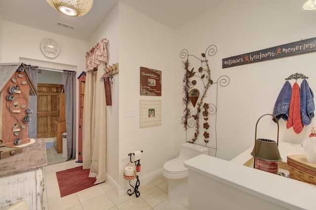 bathroom featuring tile patterned floors and toilet